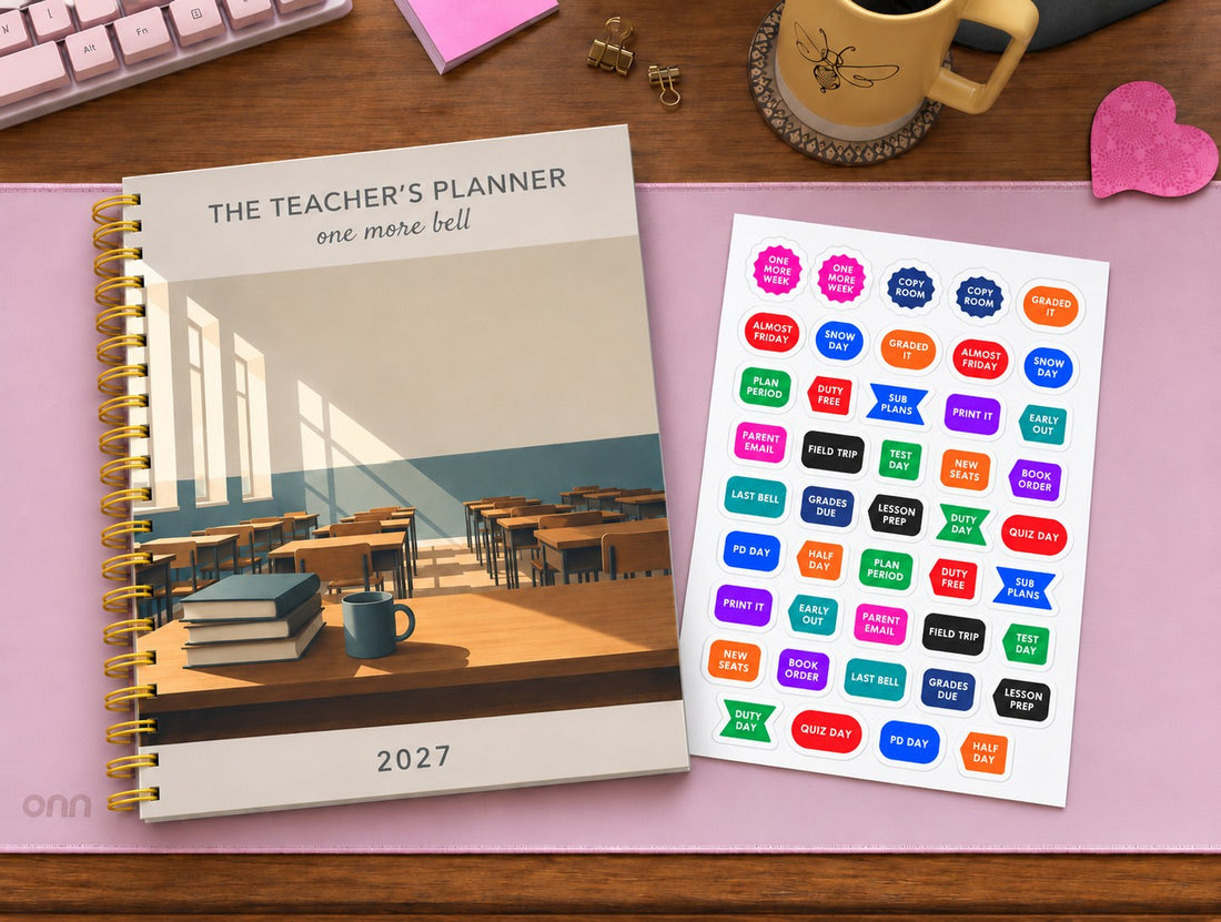 The Teacher's Planner 2027 with a classroom cover on a pink desk mat, next to a sheet of teacher stickers reading Plan Period, Sub Plans, Grades Due, Parent Email, Copy Room and Duty Day