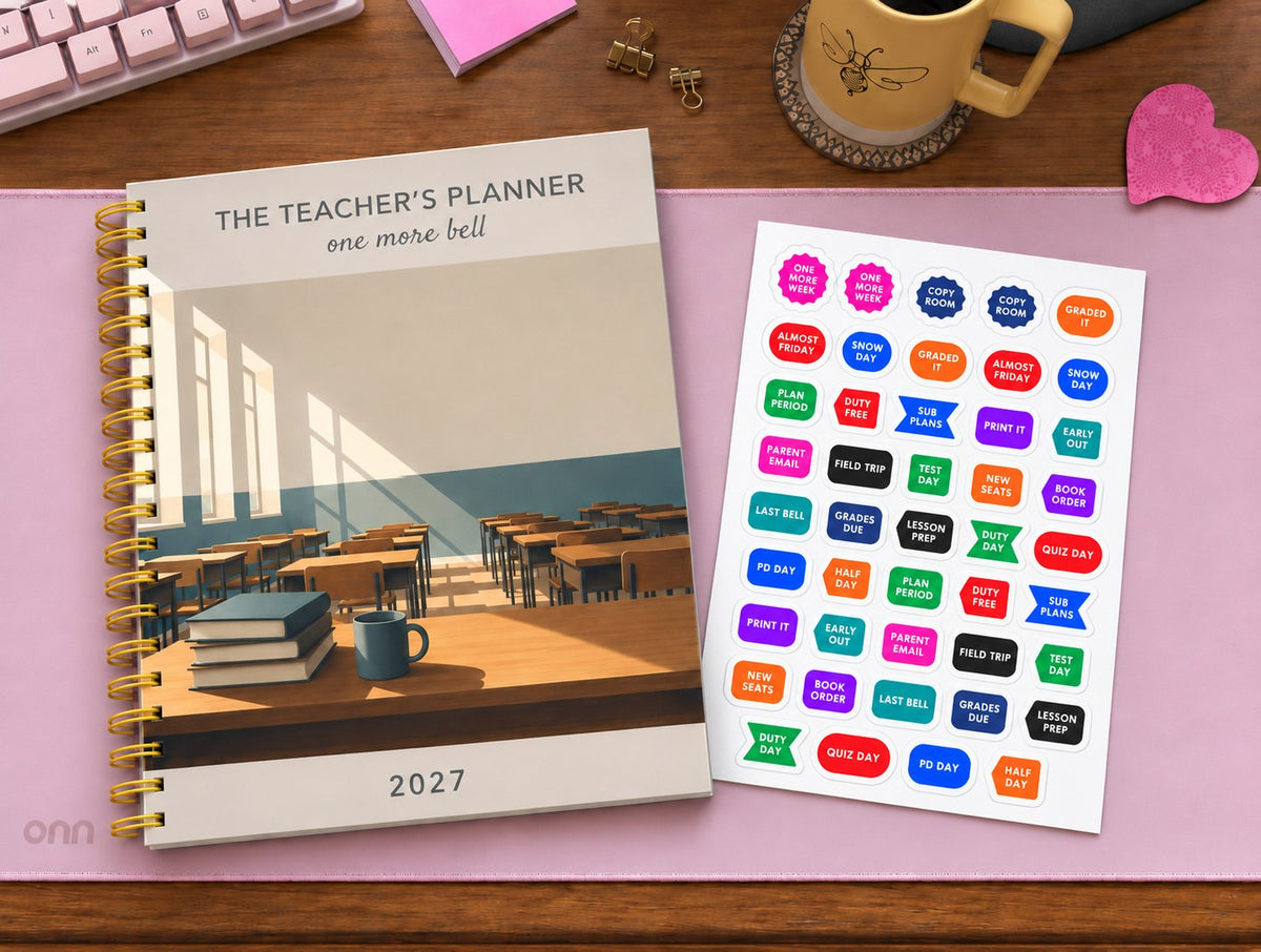 The Teacher's Planner 2027 with a classroom cover on a pink desk mat, next to a sheet of teacher stickers reading Plan Period, Sub Plans, Grades Due, Parent Email, Copy Room and Duty Day